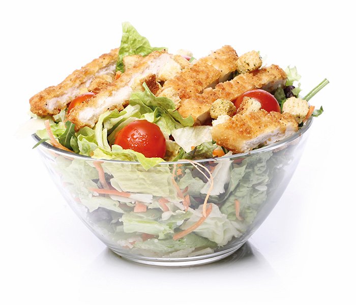 A bowl filled with salad containing chicken