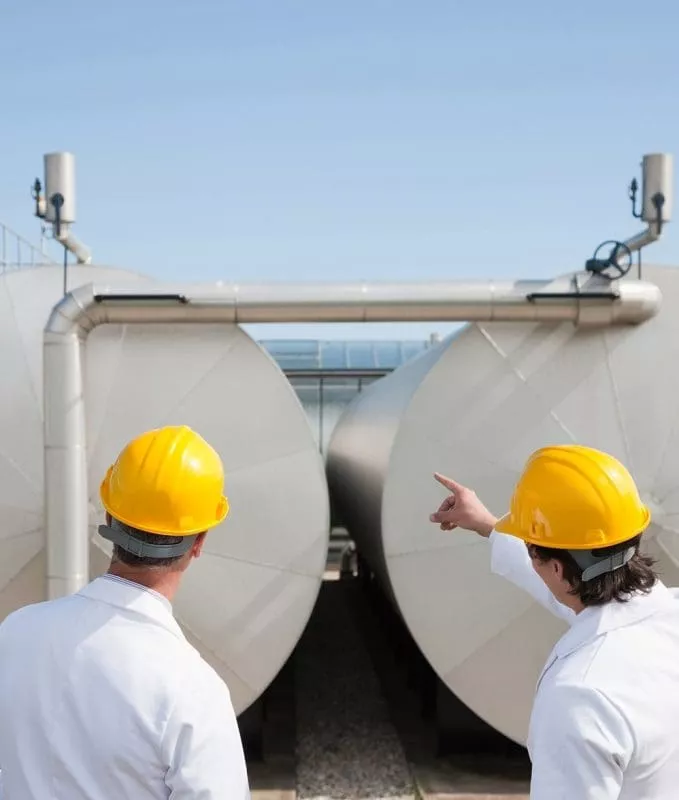 Scientists examining vats